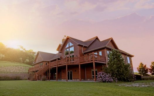brown wooden house with green grass field